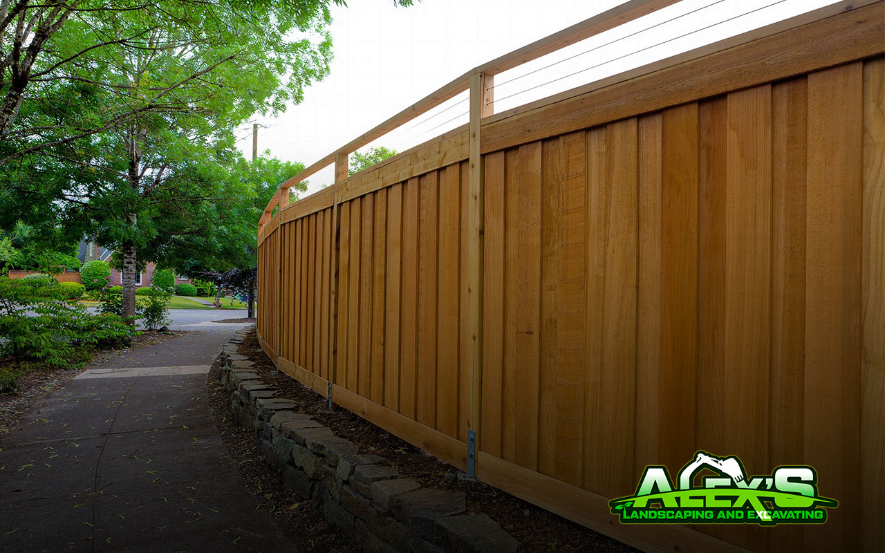 fence stain transformation completed by Alex’s Landscaping and Excavating